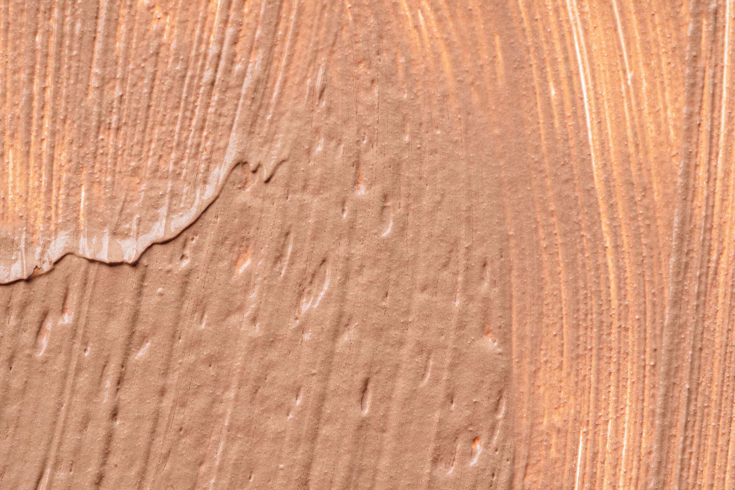 Background of a smudged cream foundation texture